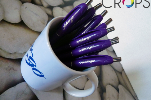 Glasses and pens with a logo