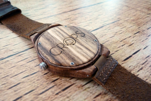 Wooden watch with engraved message, advertising agency